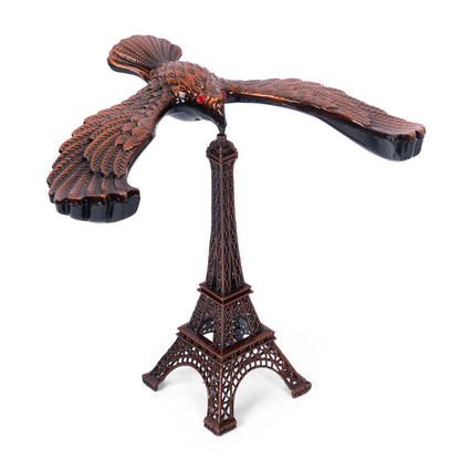 Handcrafted wooden eagle and Eiffel Tower sculpture angled view